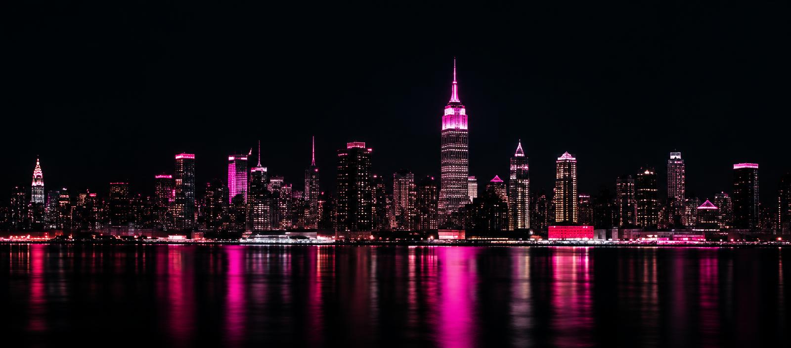 Manhattan skyline illuminated in pink at night